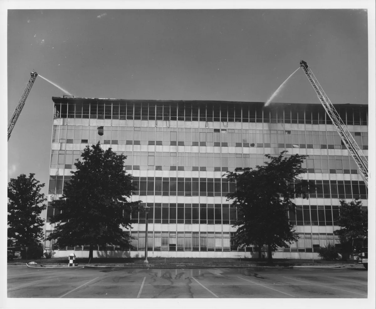 Firefighters spraying water on the burning National Personnel Records Center building in 1973